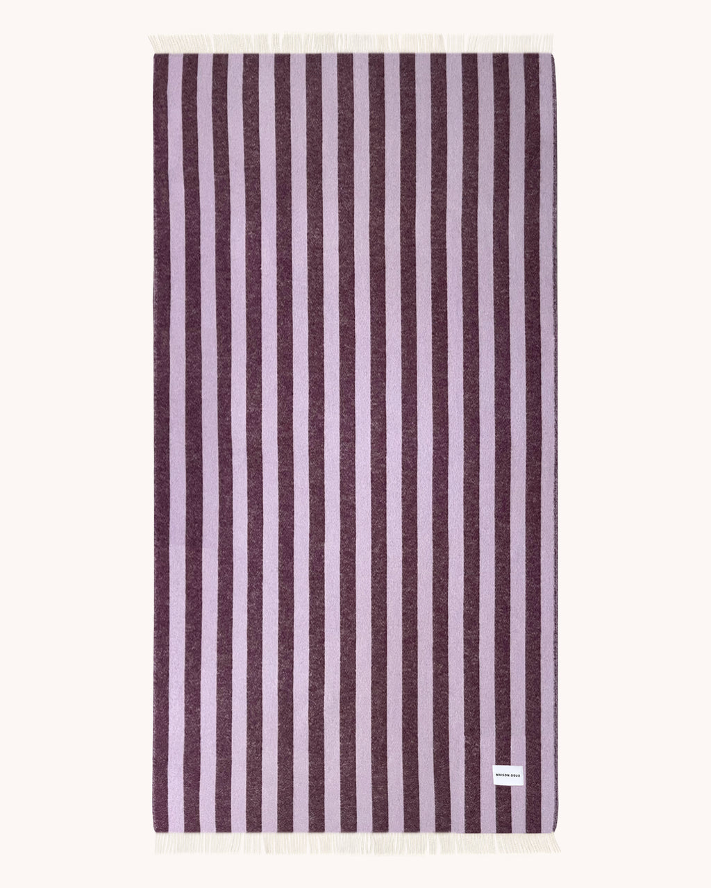 Lilac and aubergine striped wool blanket folded with fringe detail