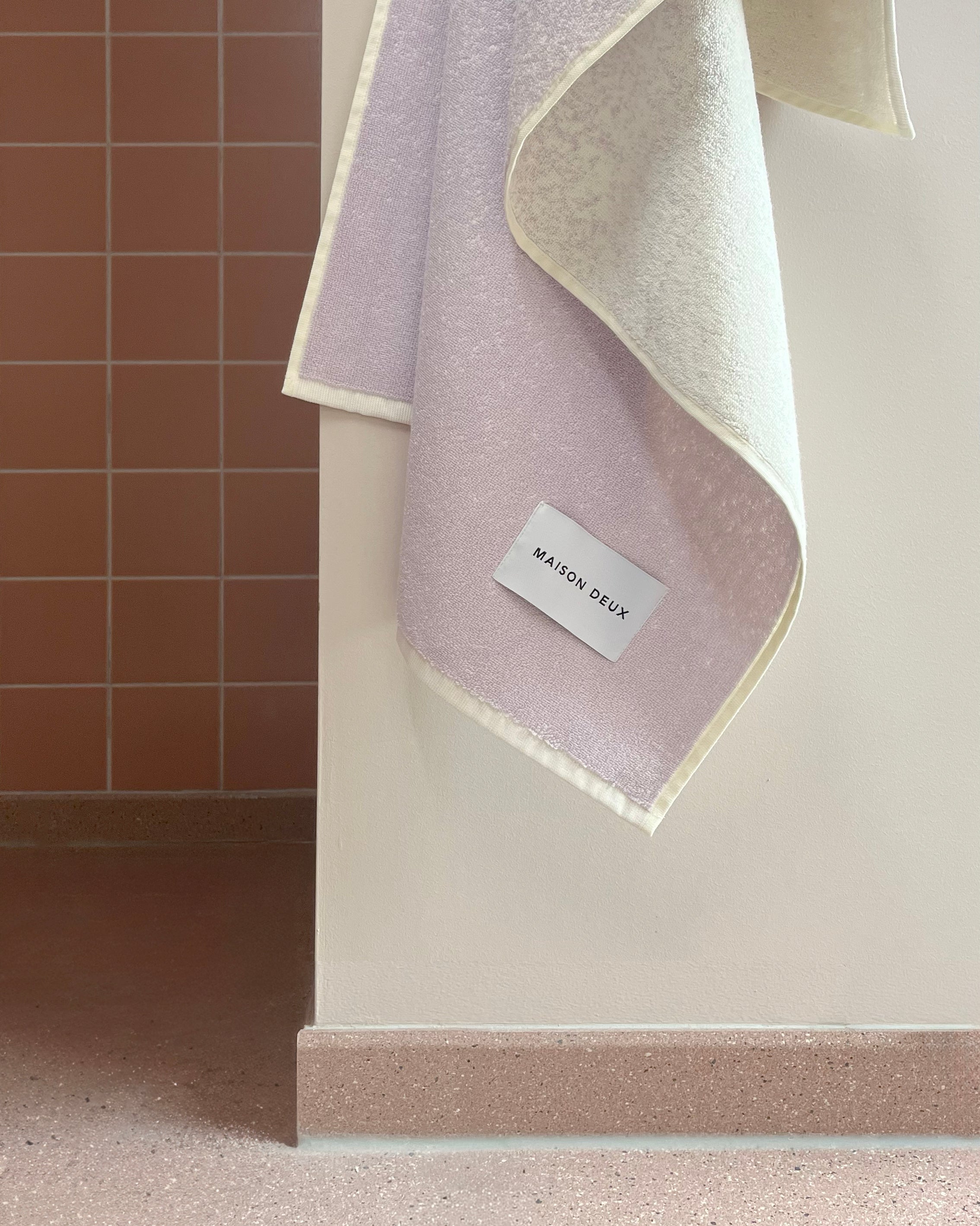 Lilac to vanilla gradient towel hanging in corner