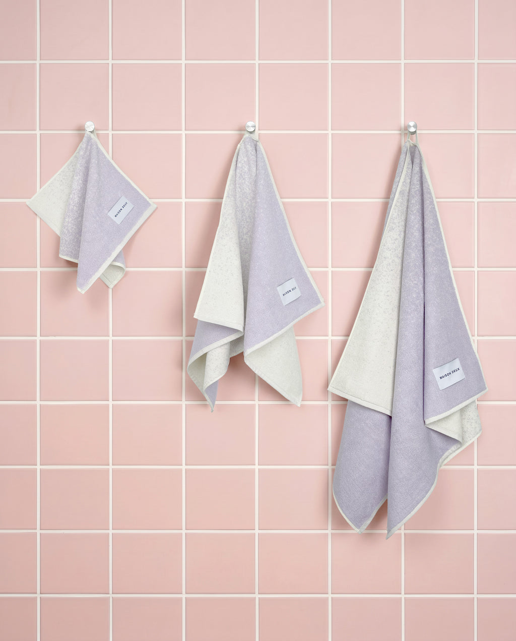 Lilac to vanilla gradient organic cotton towels shown in guest, hand and bath sizes
