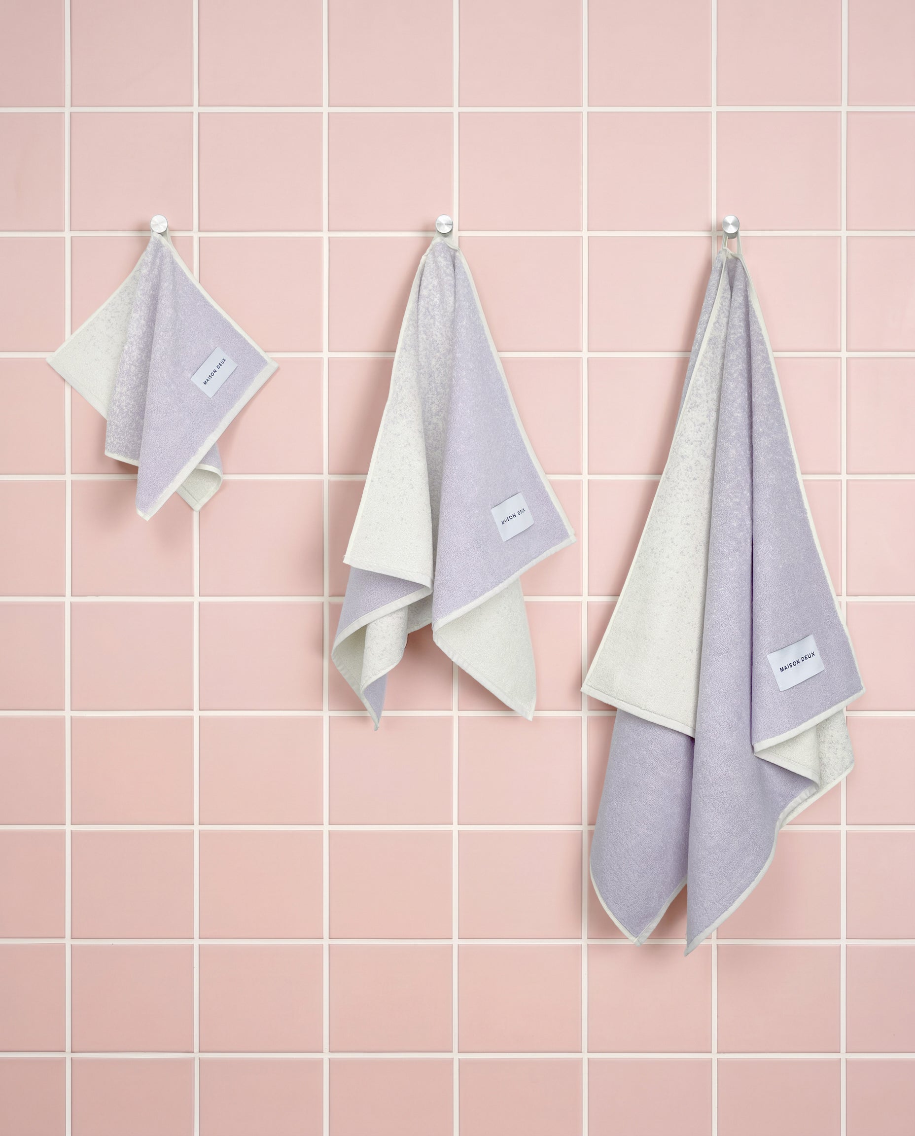Lilac to vanilla gradient organic cotton towels shown in guest, hand and bath sizes