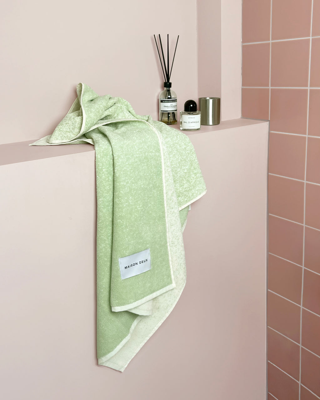 Sage to vanilla gradient towel styled on bathroom shelf