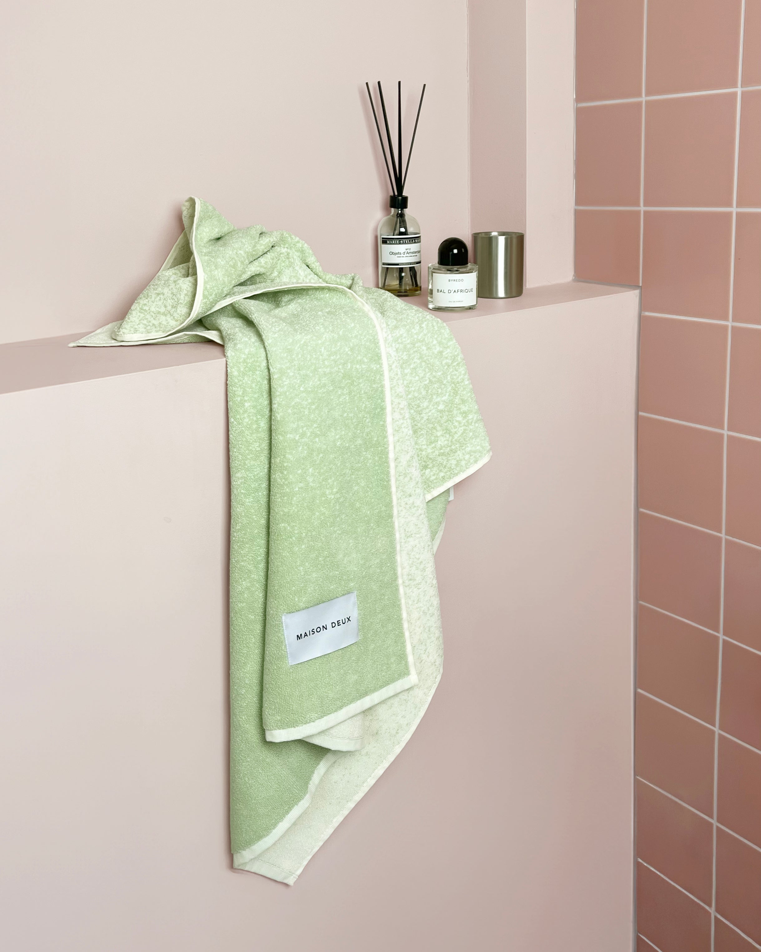 Sage to vanilla gradient towel styled on bathroom shelf