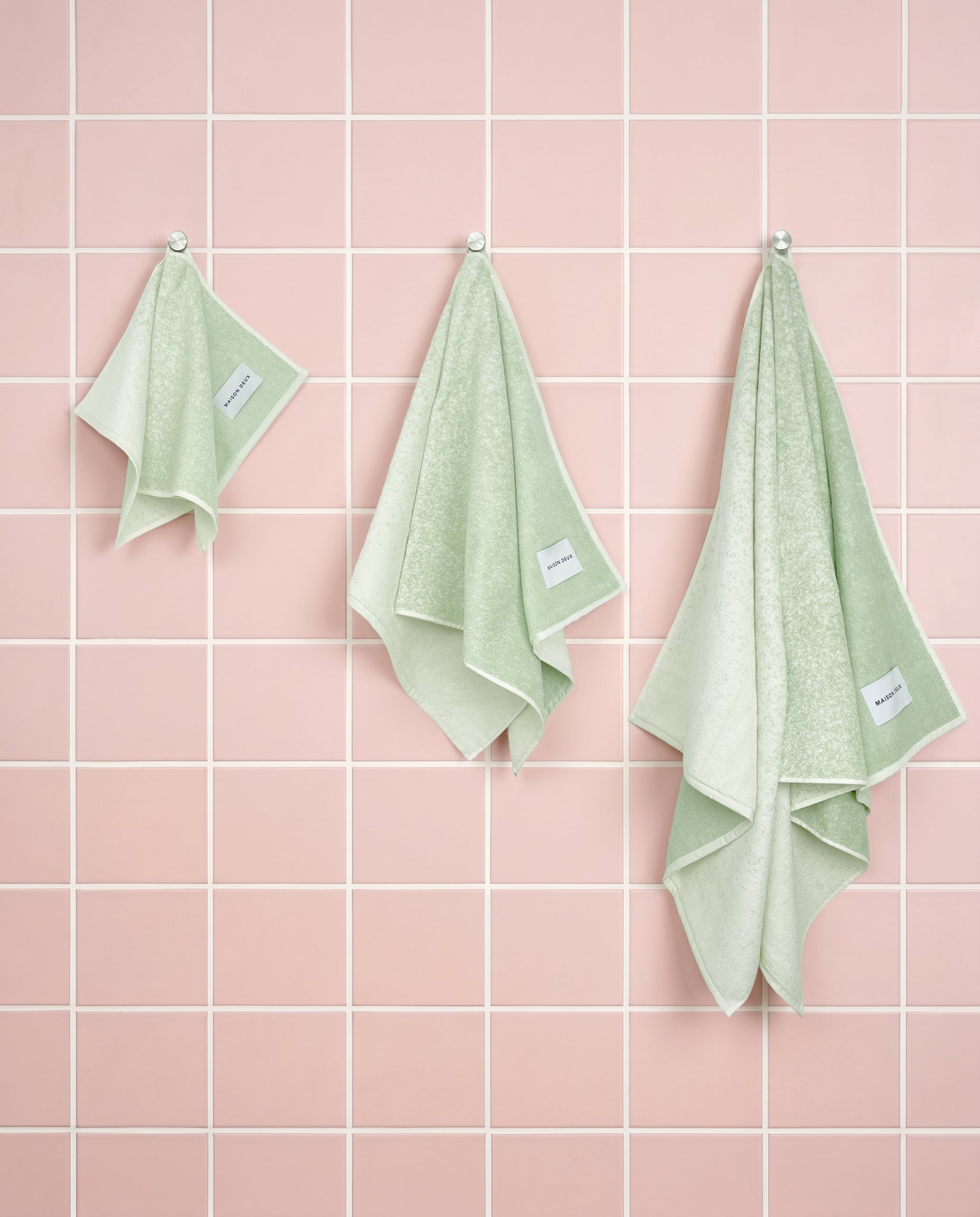 Sage to vanilla gradient organic cotton towels shown in guest, hand and bath sizes