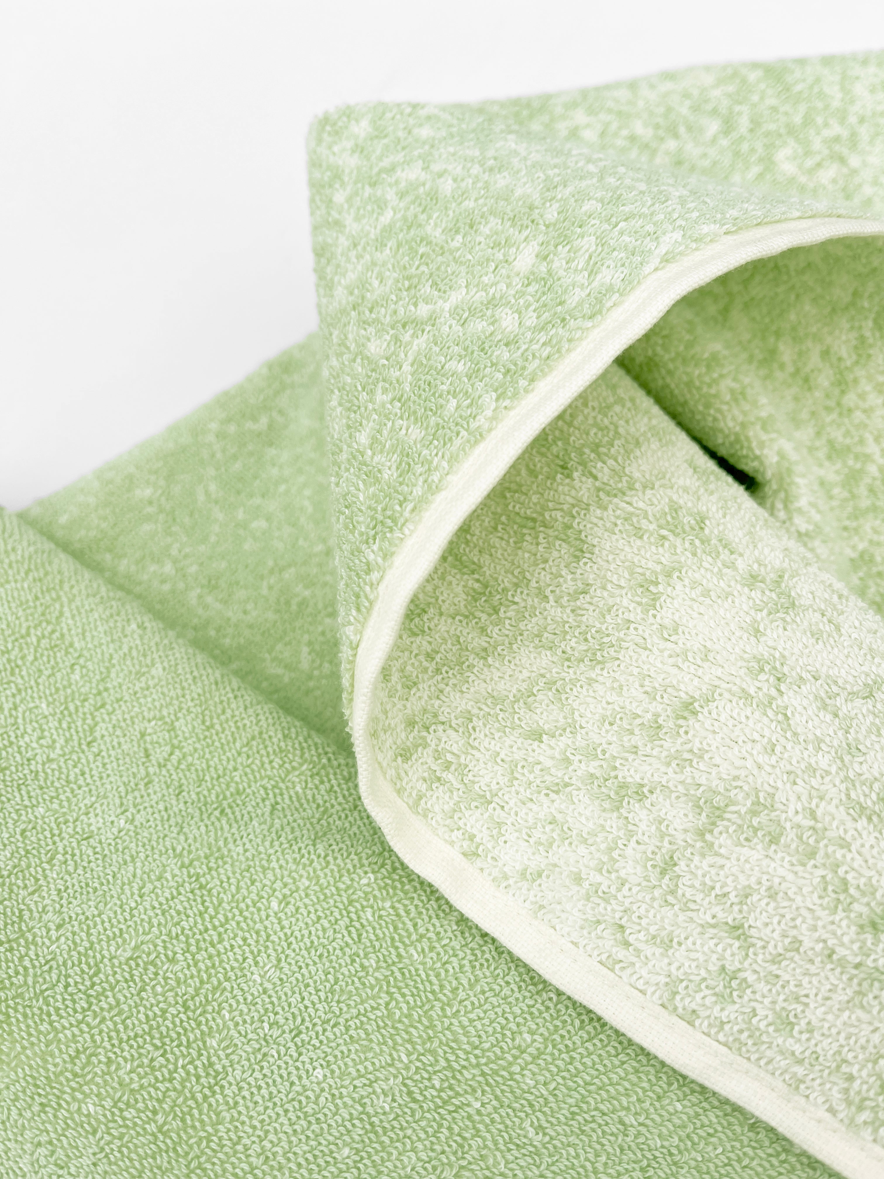 Close-up of dense GOTS-certified terry weave, sage to vanilla gradient