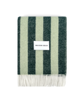Dark green and sage striped wool blanket folded with fringe detail
