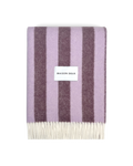Lilac and aubergine striped wool blanket folded with fringe detail

