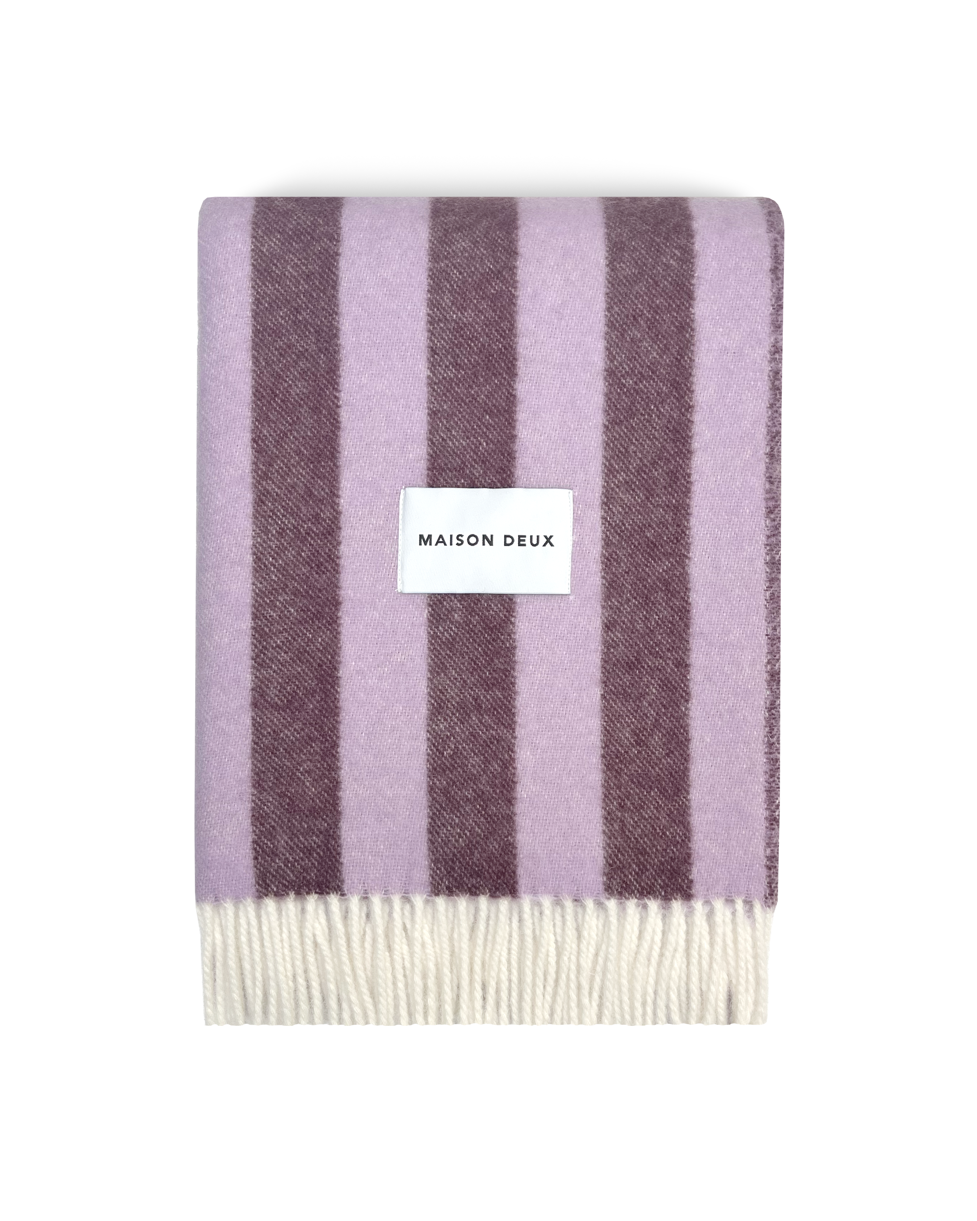 Lilac and aubergine striped wool blanket folded with fringe detail
