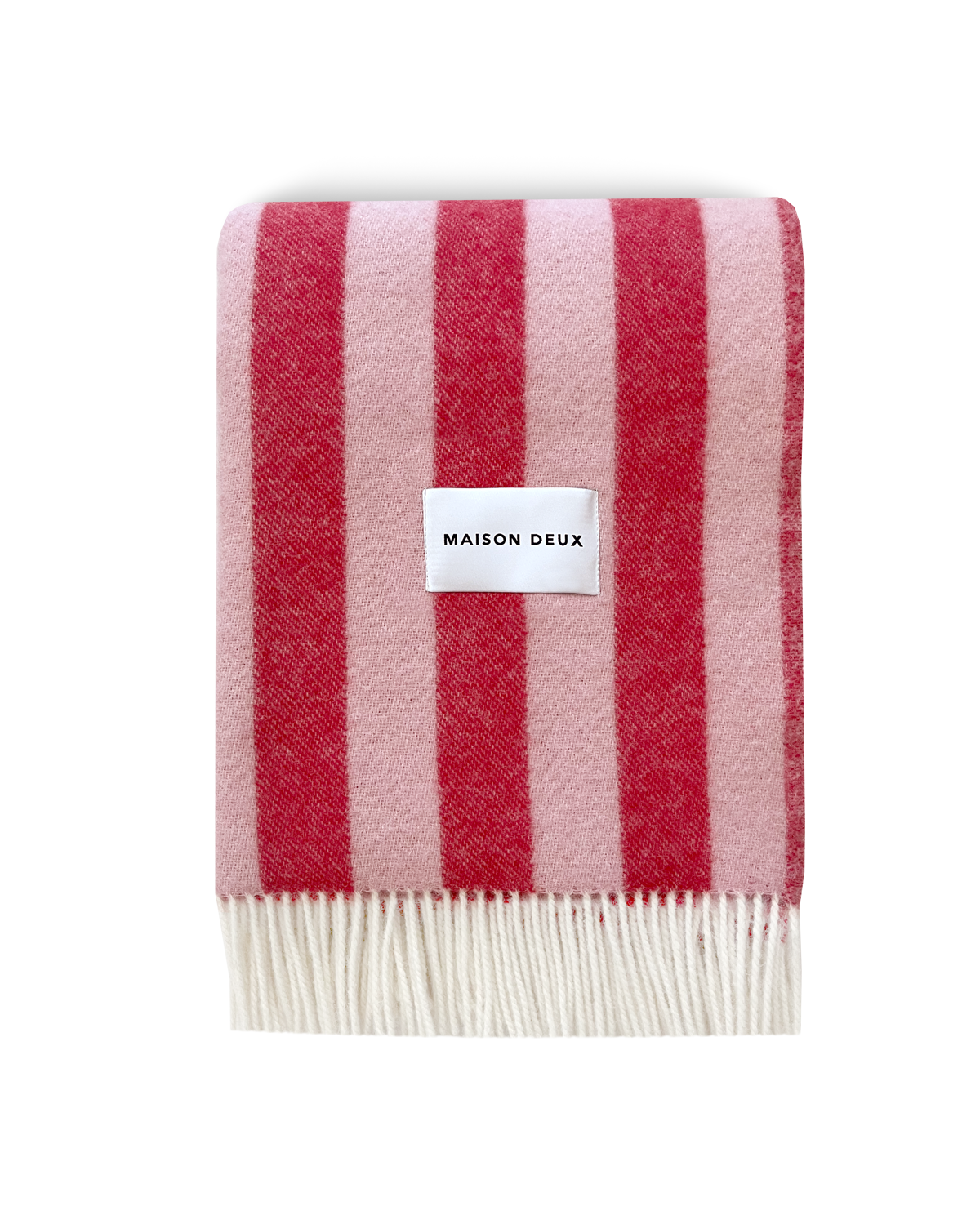 Pink and cherry red striped wool blanket folded with fringe detail
