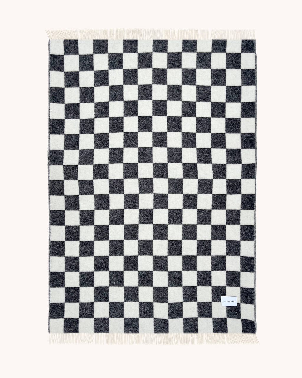 Black and white checkerboard wool throw shown flat

