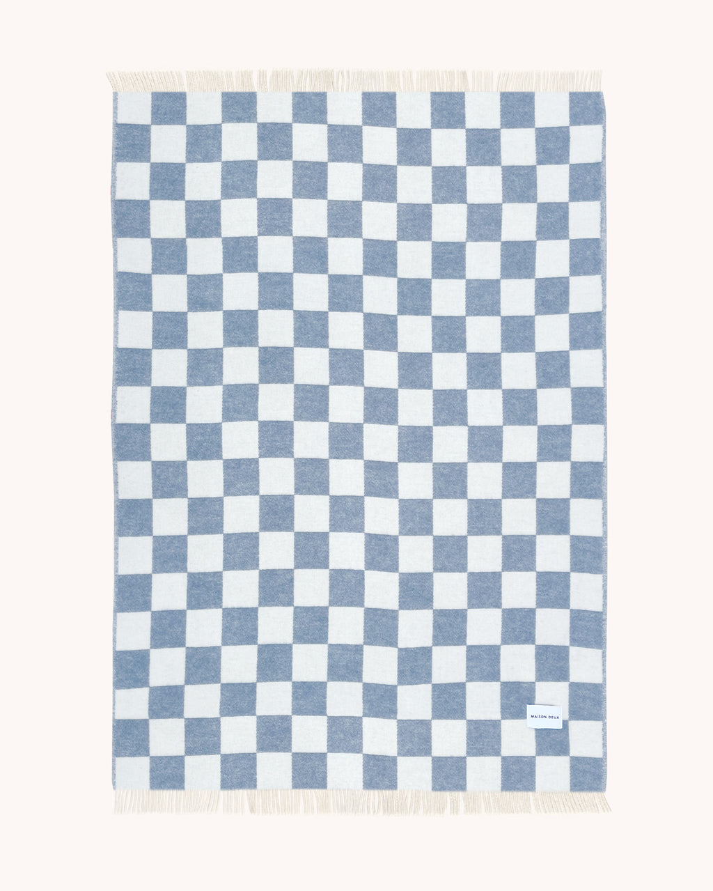 Denim blue and white checkerboard wool throw shown flat
