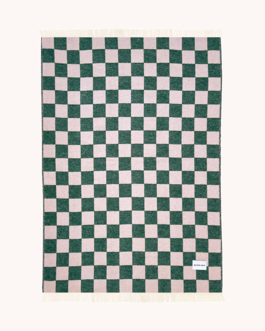 Green and pink checkerboard wool throw shown flat
