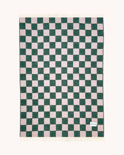 Green and pink checkerboard wool throw shown flat
