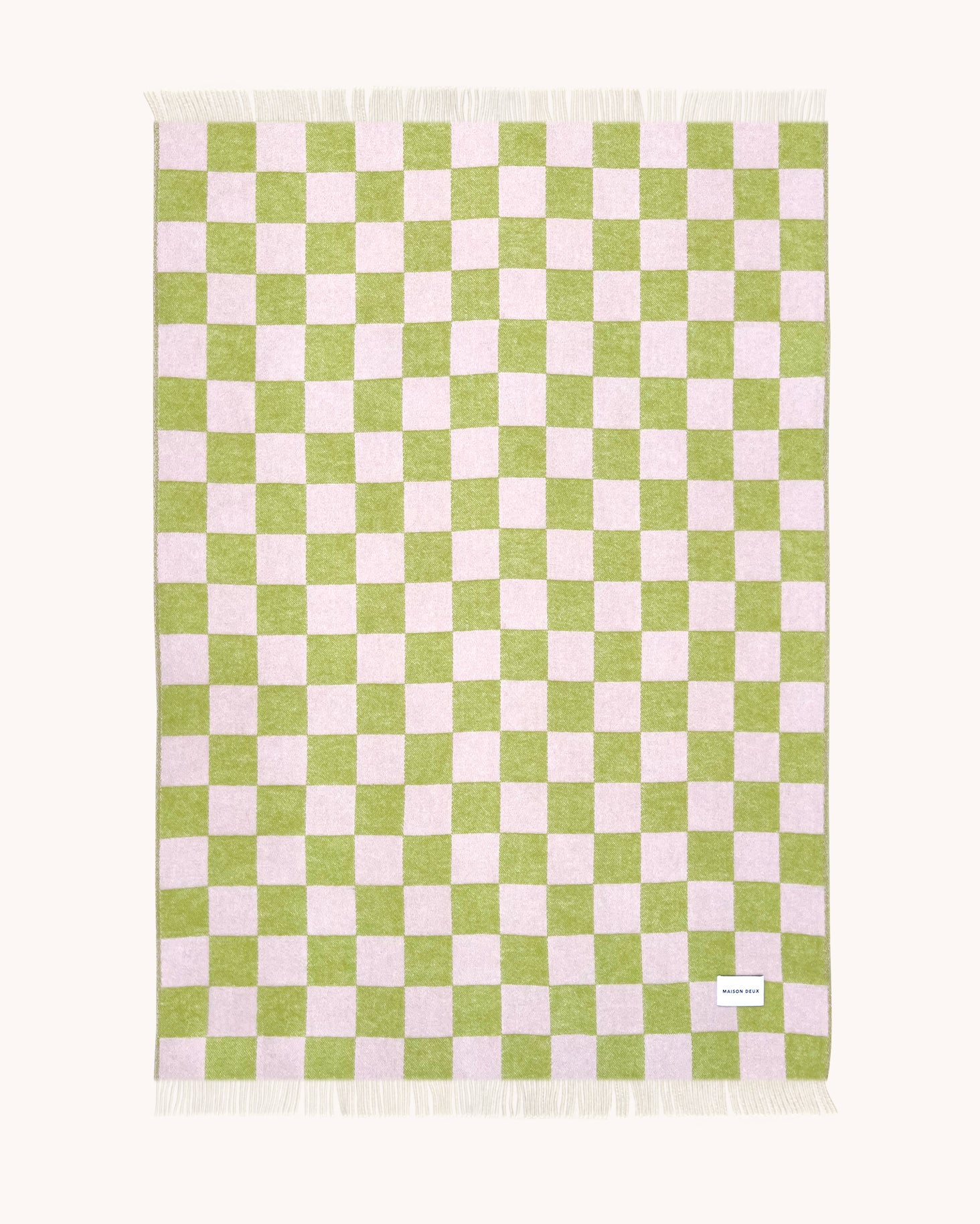 Lime green and pink checkerboard wool throw shown flat
