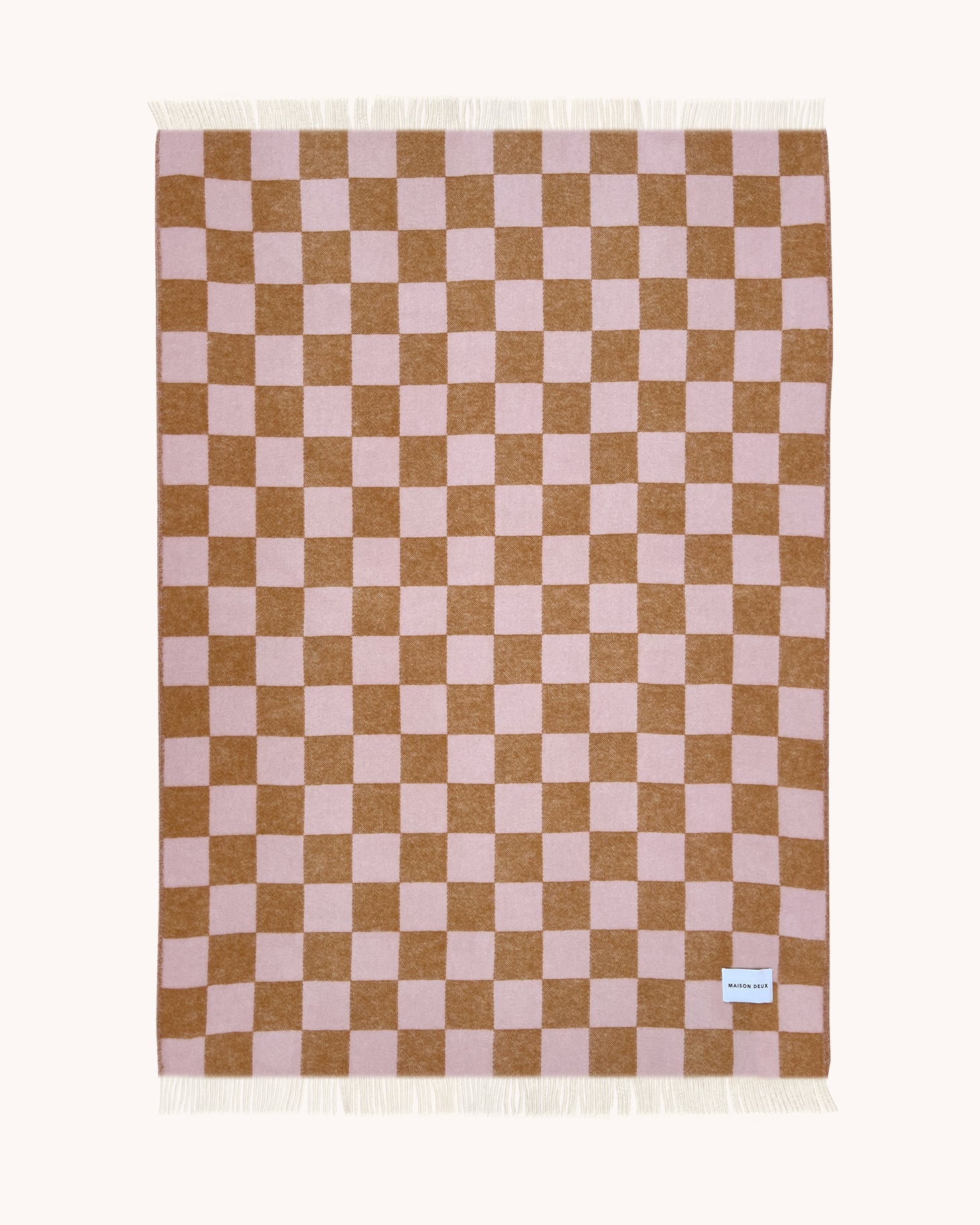 Terracotta and pink checkerboard wool throw shown flat
