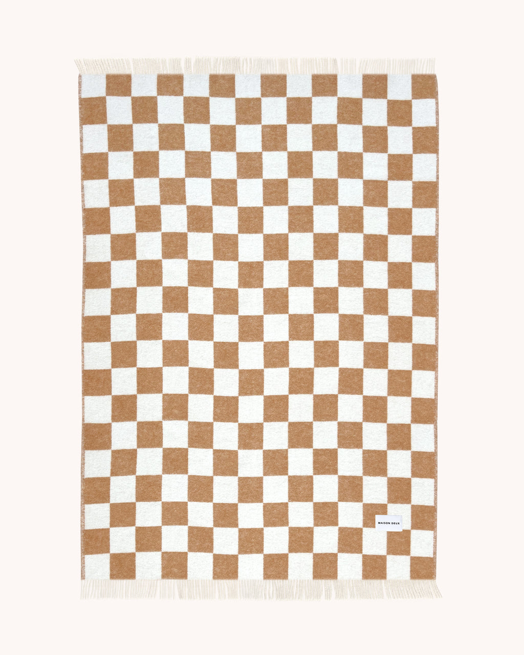 Terracotta and white checkerboard wool throw shown flat
