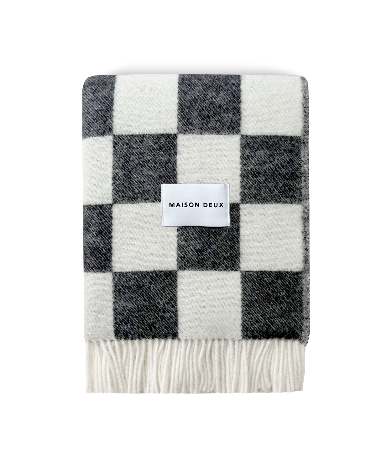 Black and white checkerboard wool blanket folded with fringe detail
