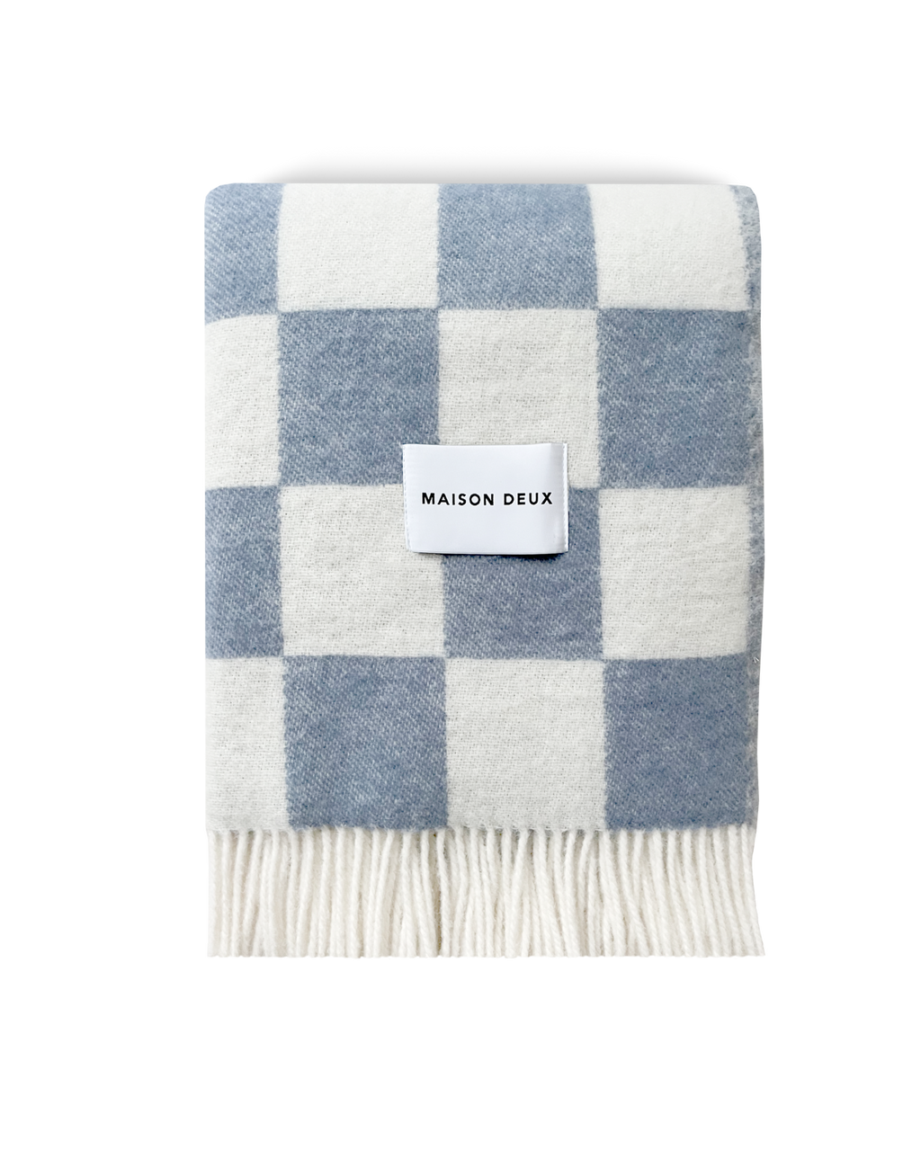 Denim blue and white checkerboard wool blanket folded with fringe detail
