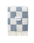 Denim blue and white checkerboard wool blanket folded with fringe detail
