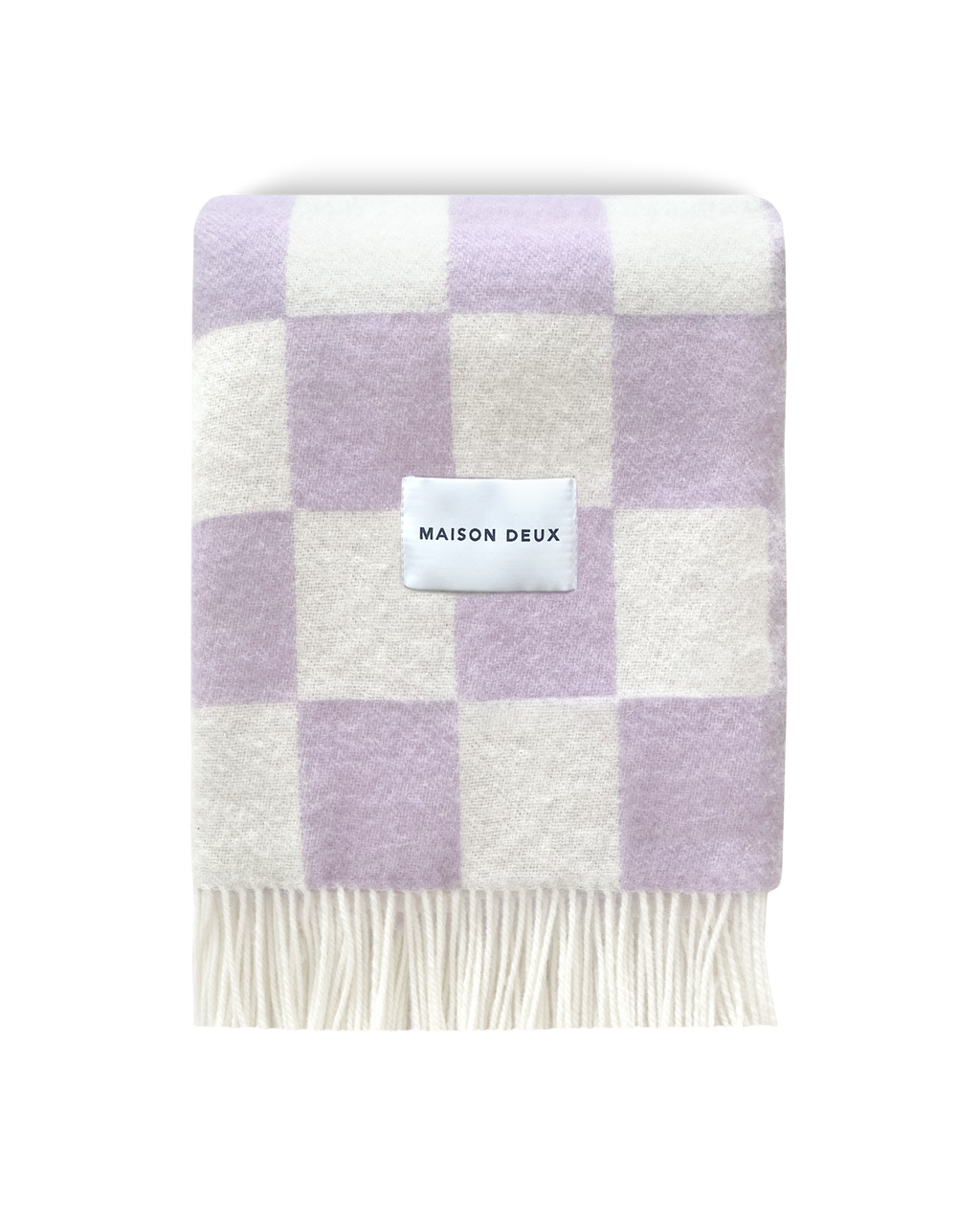 Lilac and white checkerboard wool blanket folded with fringe detail
