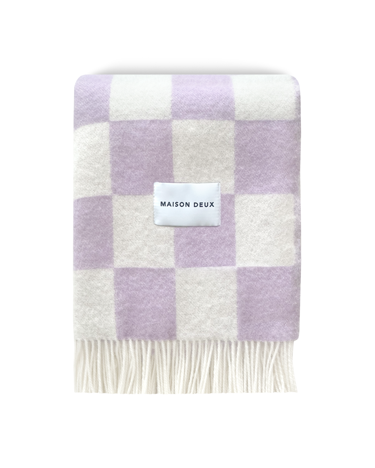 Lilac and white checkerboard wool blanket folded with fringe detail
