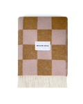 Terracotta and pink checkerboard wool blanket folded with fringe detail
