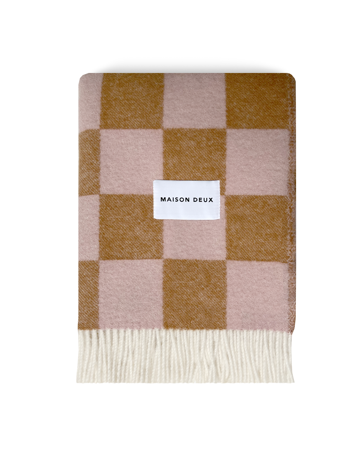 Terracotta and pink checkerboard wool blanket folded with fringe detail
