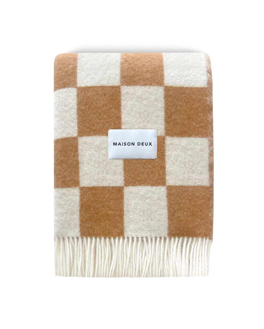 Terracotta and white checkerboard wool blanket folded with fringe detail
