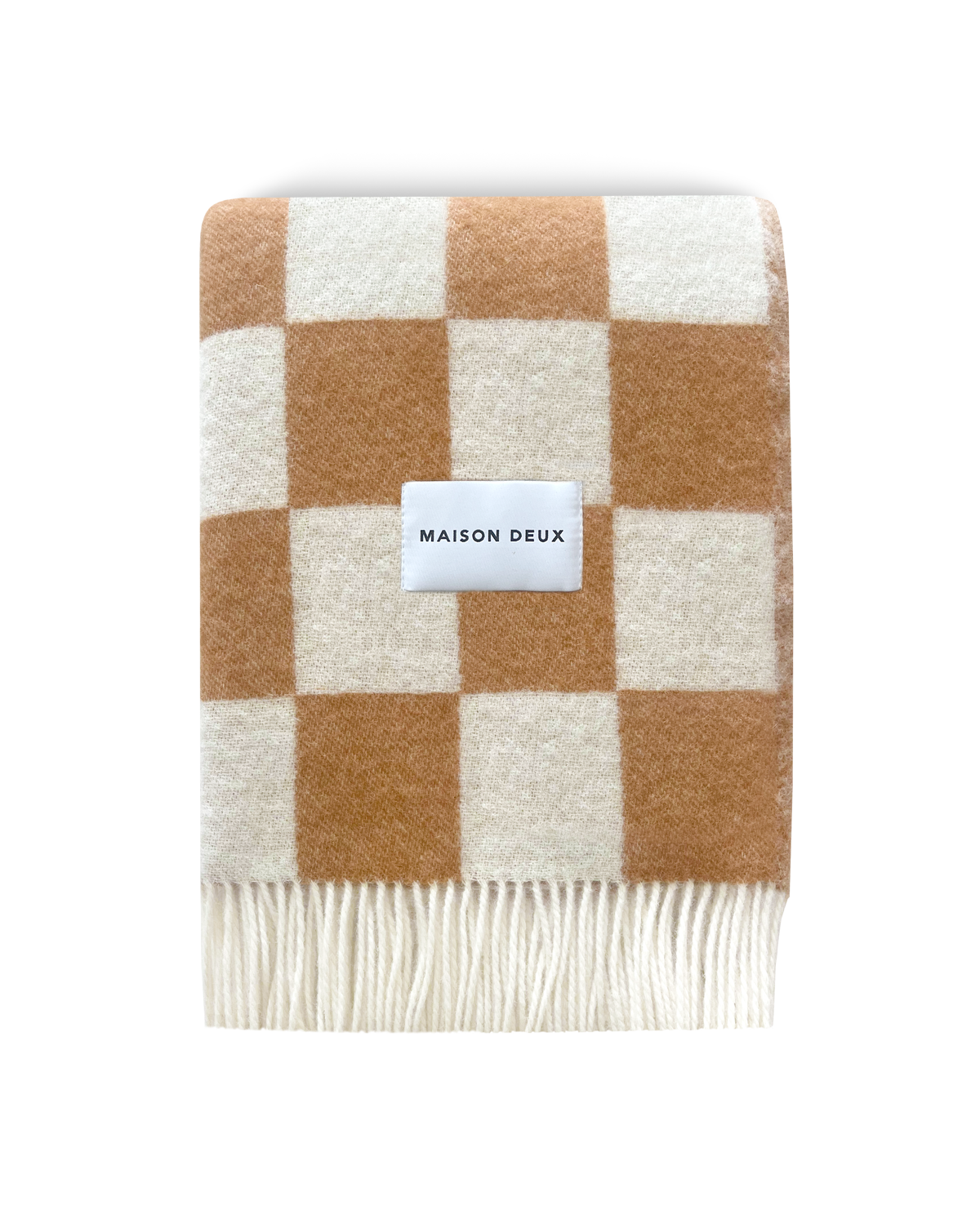 Terracotta and white checkerboard wool blanket folded with fringe detail
