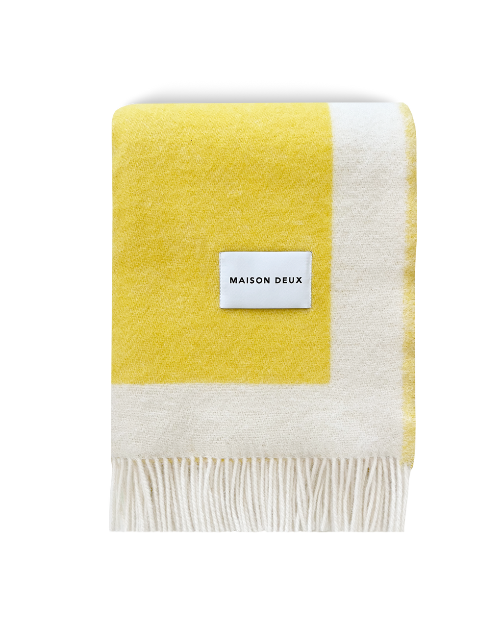 Yellow and white wool blanket folded with fringe detail
