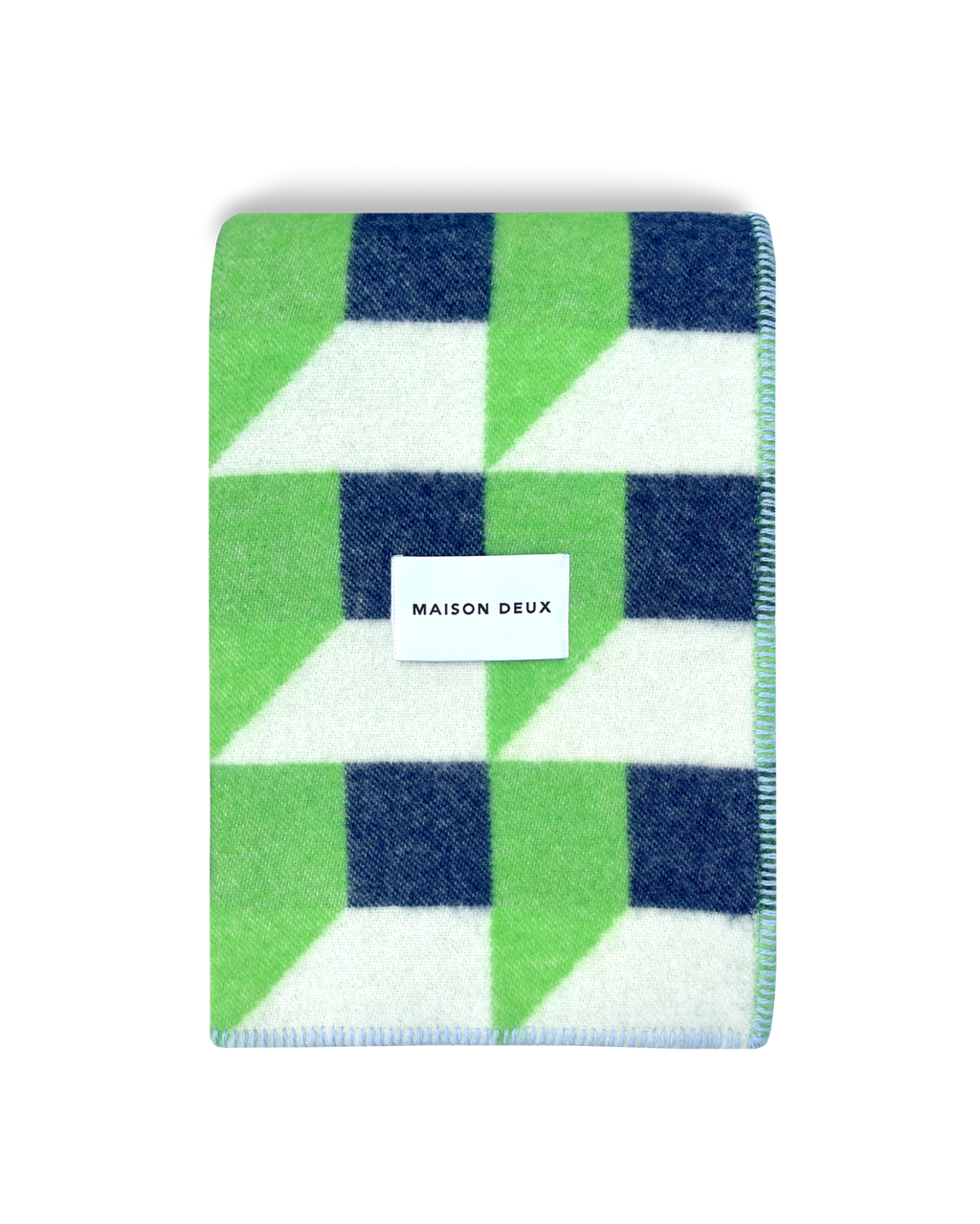 Apple green and navy geometric wool blanket folded with stitched edge detail
