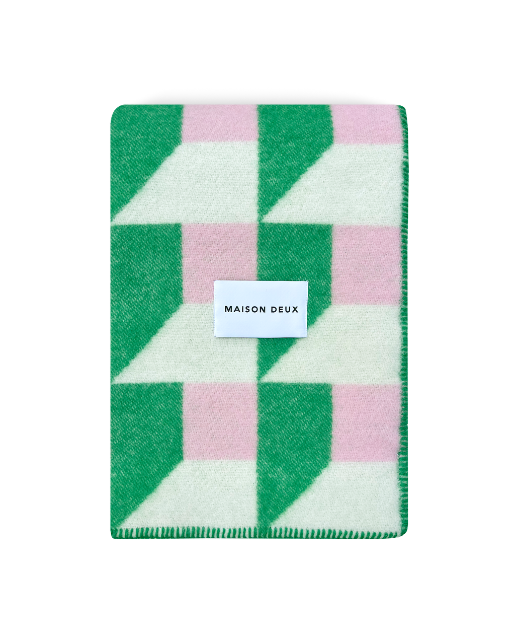 Grass green and pink geometric wool blanket folded with stitched edge detail
