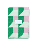 Grass green and pink geometric wool blanket folded with stitched edge detail
