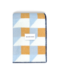 Light blue and honey yellow geometric wool blanket folded with stitched edge detail
