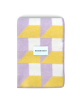Lilac and yellow geometric wool blanket folded with stitched edge detail
