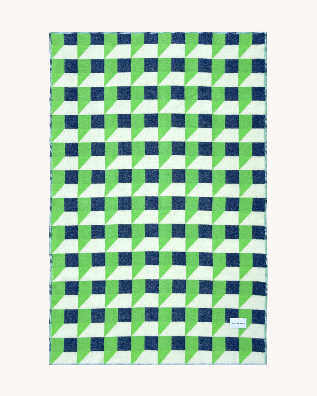 Apple green and navy geometric wool throw shown flat
