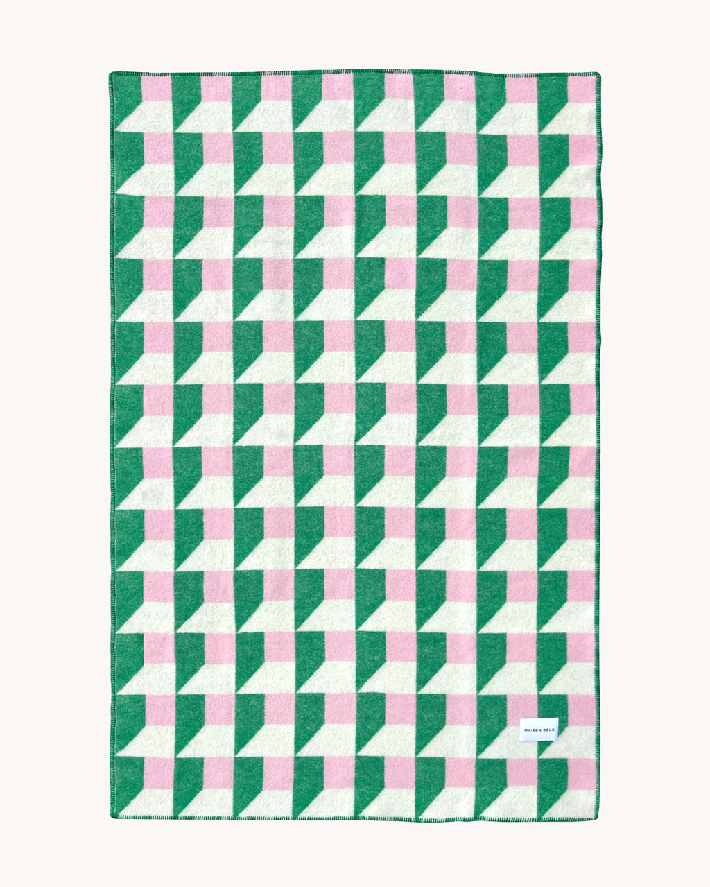 Grass green and pink geometric wool throw shown flat
