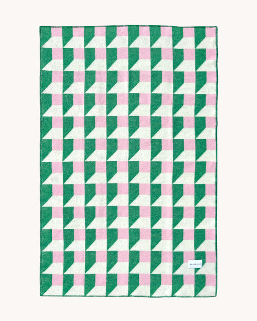 Grass green and pink geometric wool throw shown flat
