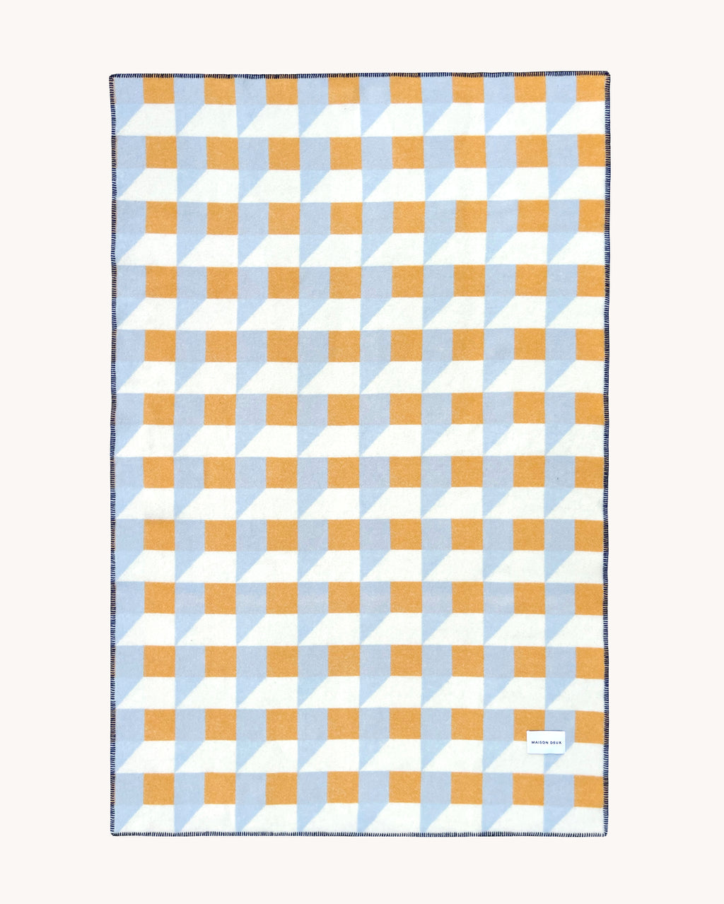 Light blue and honey yellow geometric wool throw shown flat
