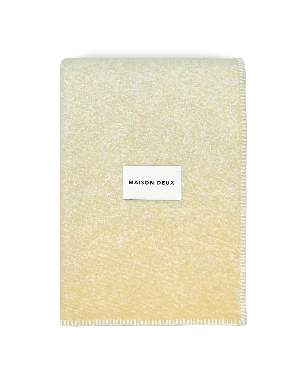  Butter yellow wool blanket folded with stitched edge detail
