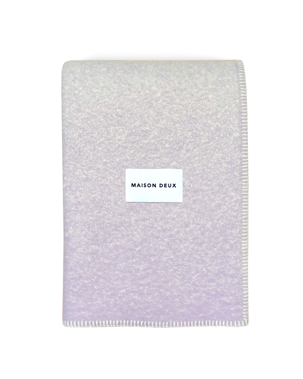 Lilac wool blanket folded with stitched edge detail
