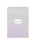 Lilac wool blanket folded with stitched edge detail
