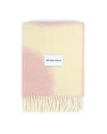 Butter yellow and pink wool blanket folded with fringe detail
