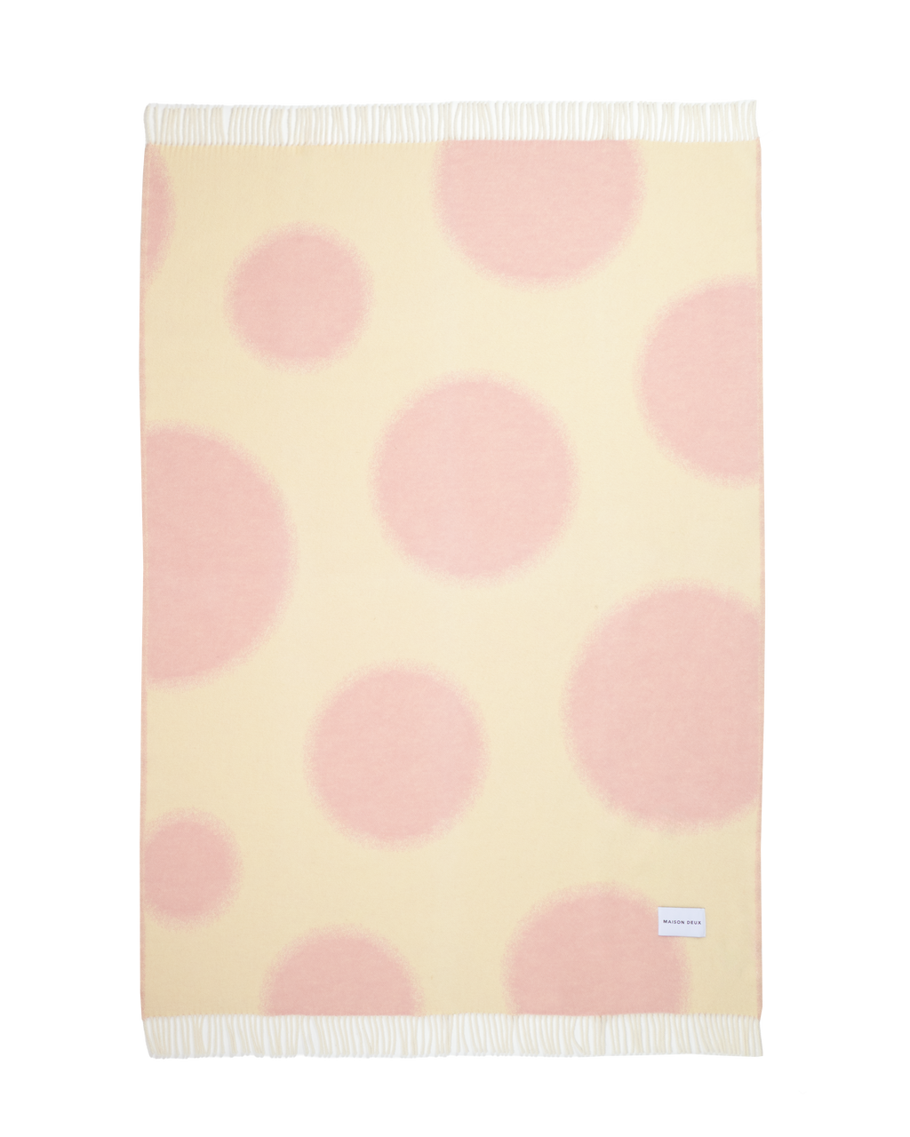 Butter yellow and pink polka dot wool throw shown flat

