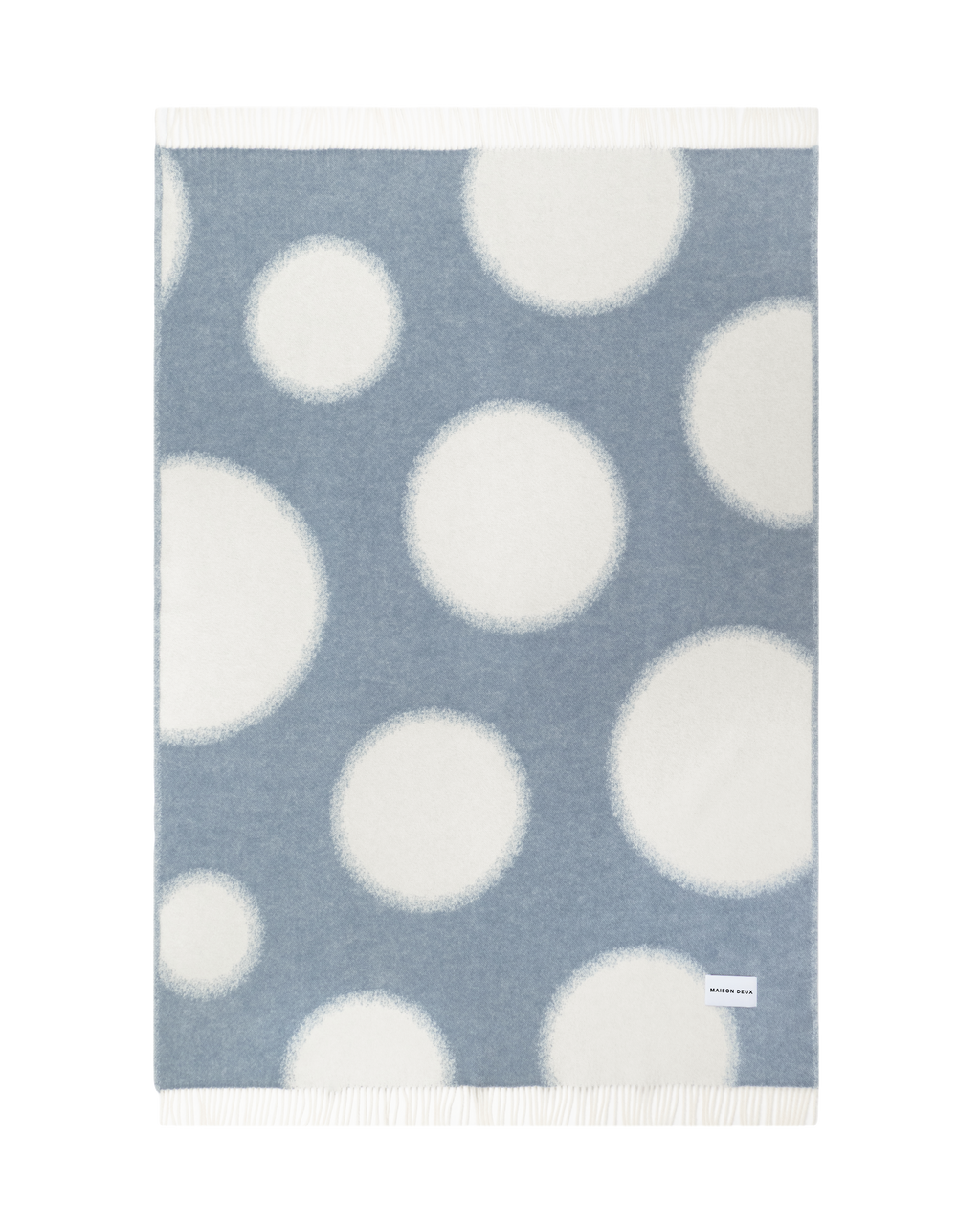 Denim blue and white polka dot wool throw shown flat
