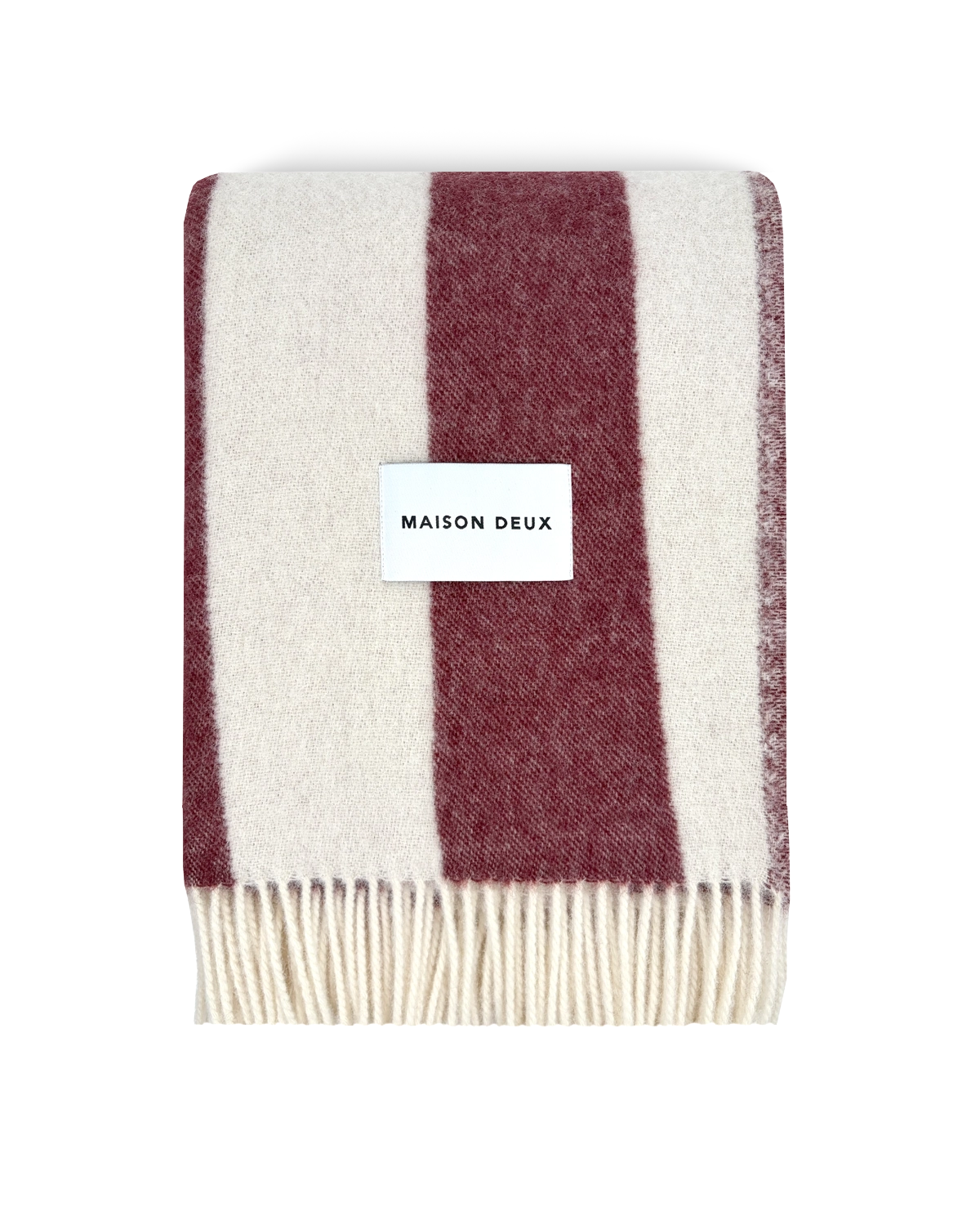 Merlot and white striped wool blanket folded with fringe detail
