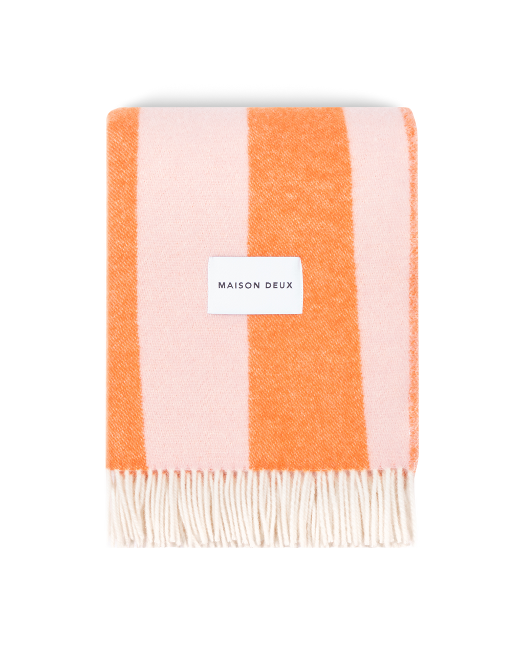 Pink and carrot orange striped wool blanket folded with fringe detail
