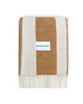 Terracotta and white striped wool blanket folded with fringe detail
