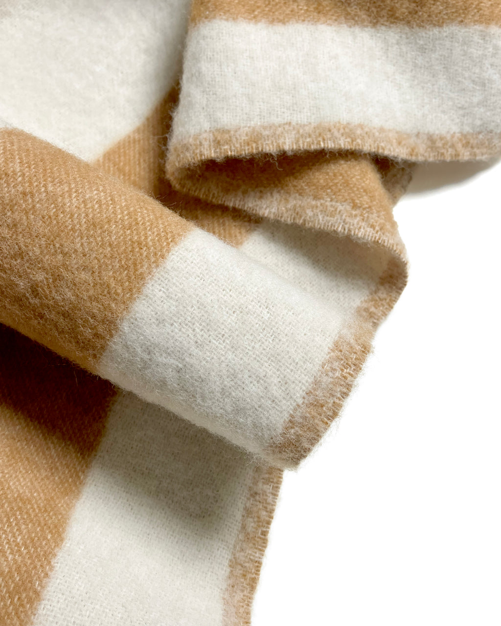 Close-up of terracotta and white striped wool plaid with fringe
