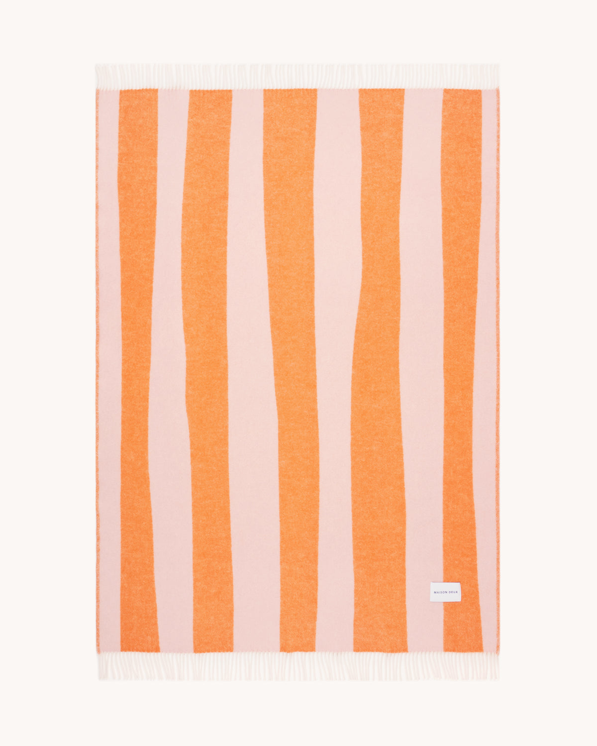 Pink and carrot orange striped wool throw shown flat
