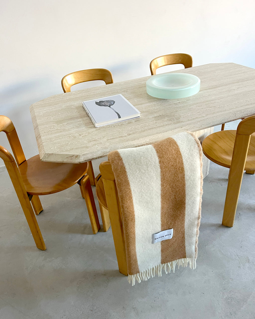 Terracotta and white striped wool throw draped over dining table
